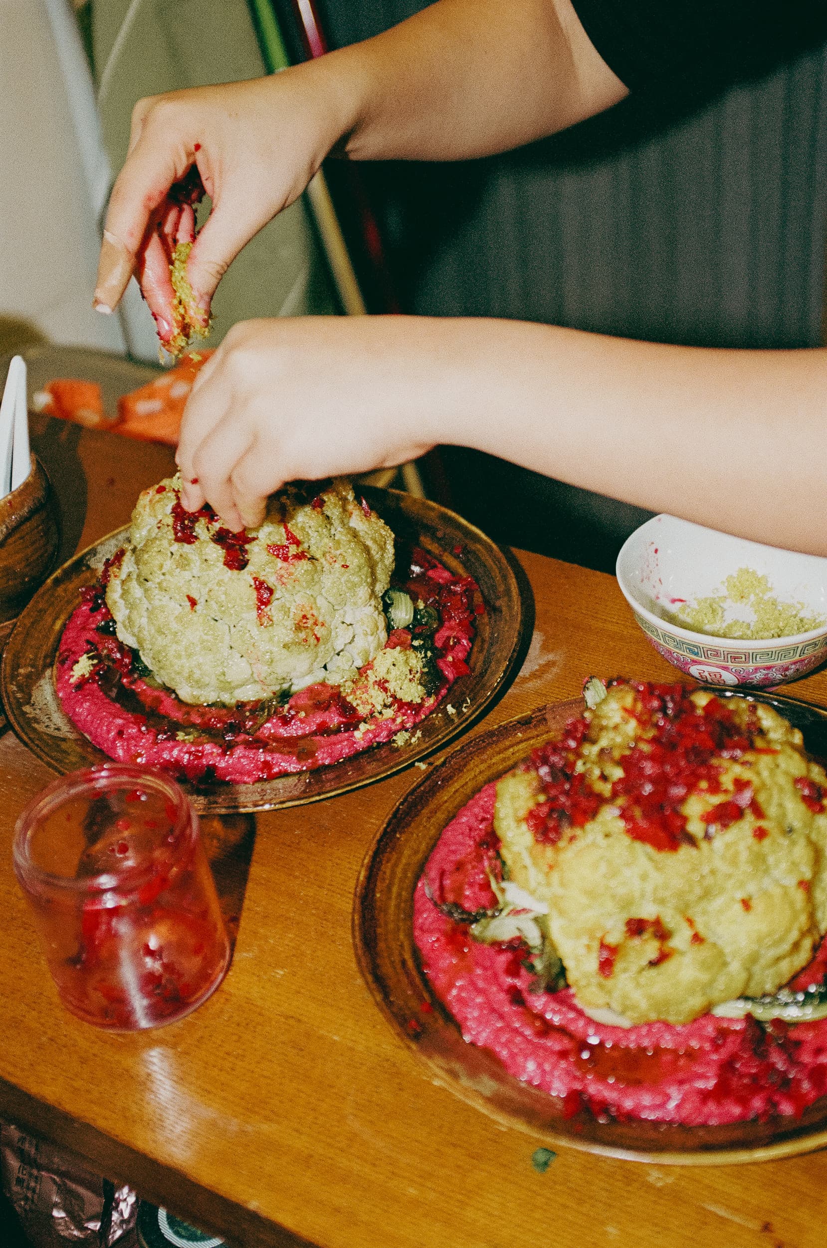 Roasted whole cauliflower on beet hummus