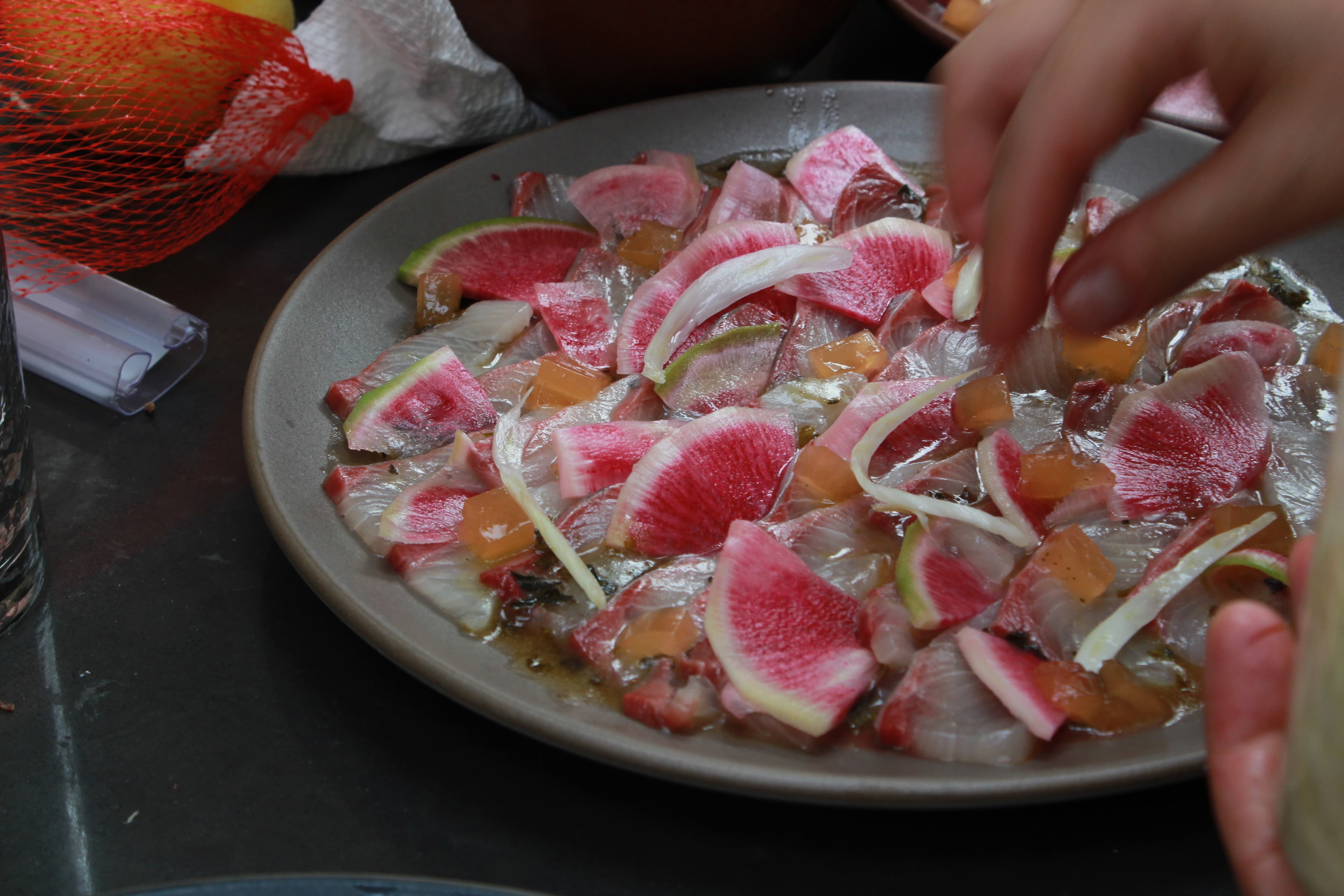 Kampachi crudo with watermelon radish, strawberry gyokuro consomme, and tomato dashi jelly